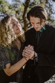 couple praying and holding hands