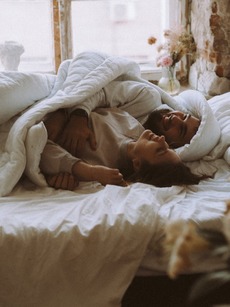 couple saying a praying in bed