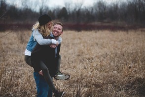 couple hiking with girl on guy's back