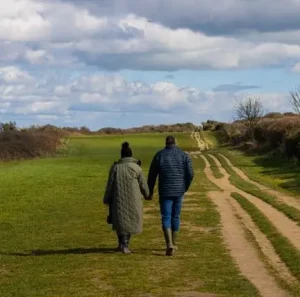 couple walking in a field